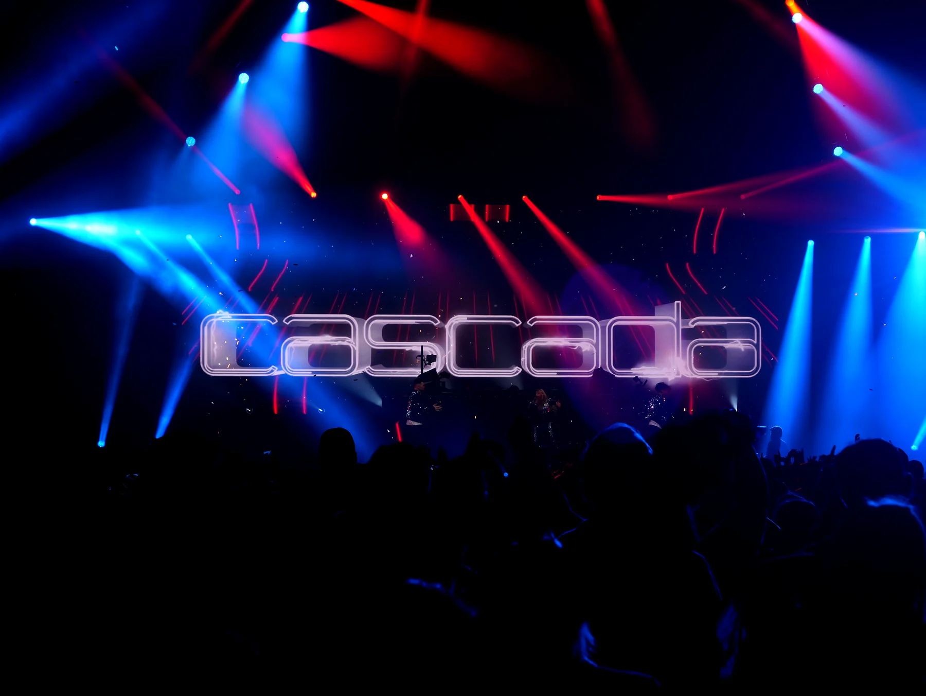 Red and blue lasers firing over the crowd towards a stage screen showing the Cascada logo