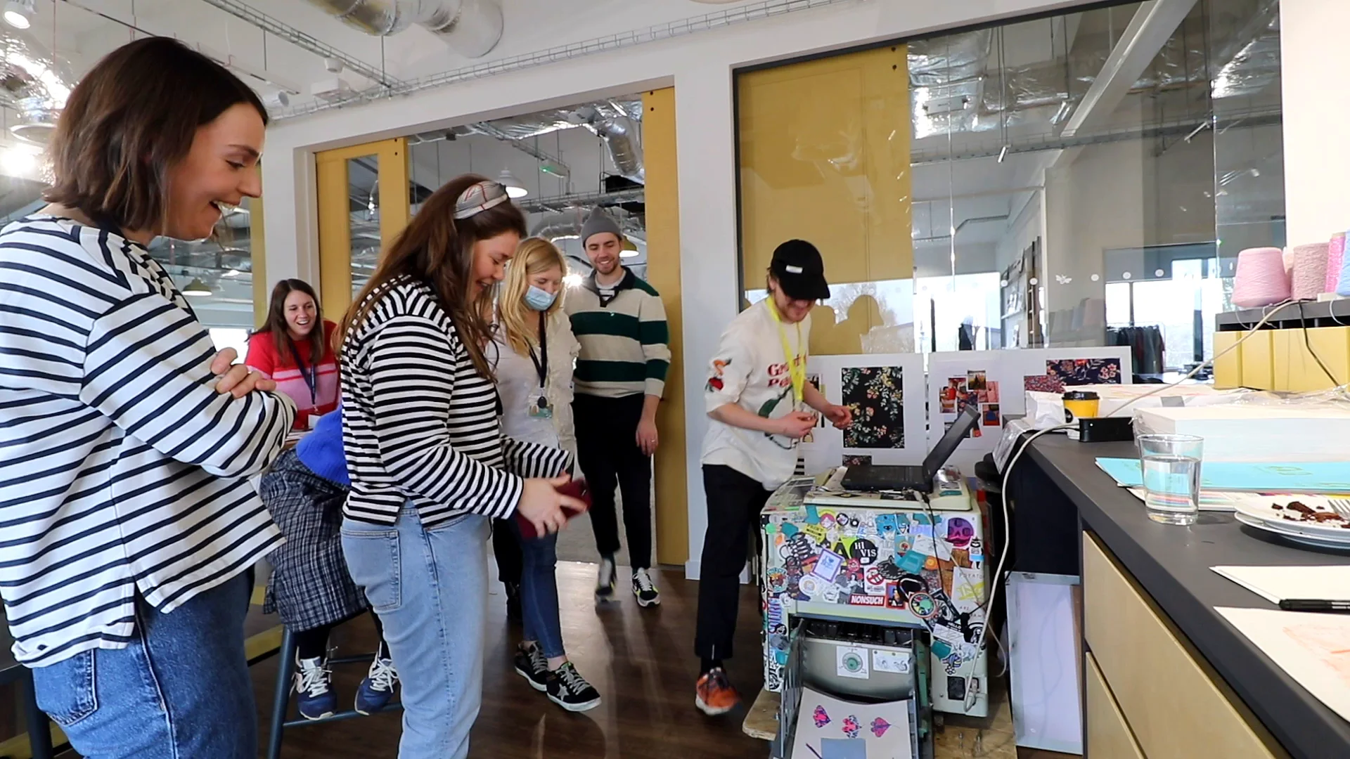 Joules team members in breton stripes gathered at the press, smiling at the results