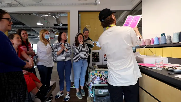 The Joules team cheering as a fresh pink risograph print is held up