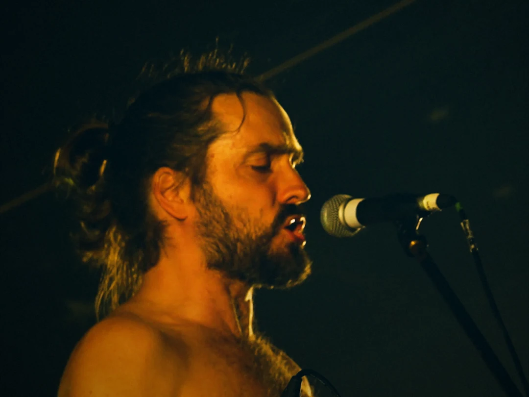 Singer performing live at Solfest 2025, graded with warm skin tones and teal shadows