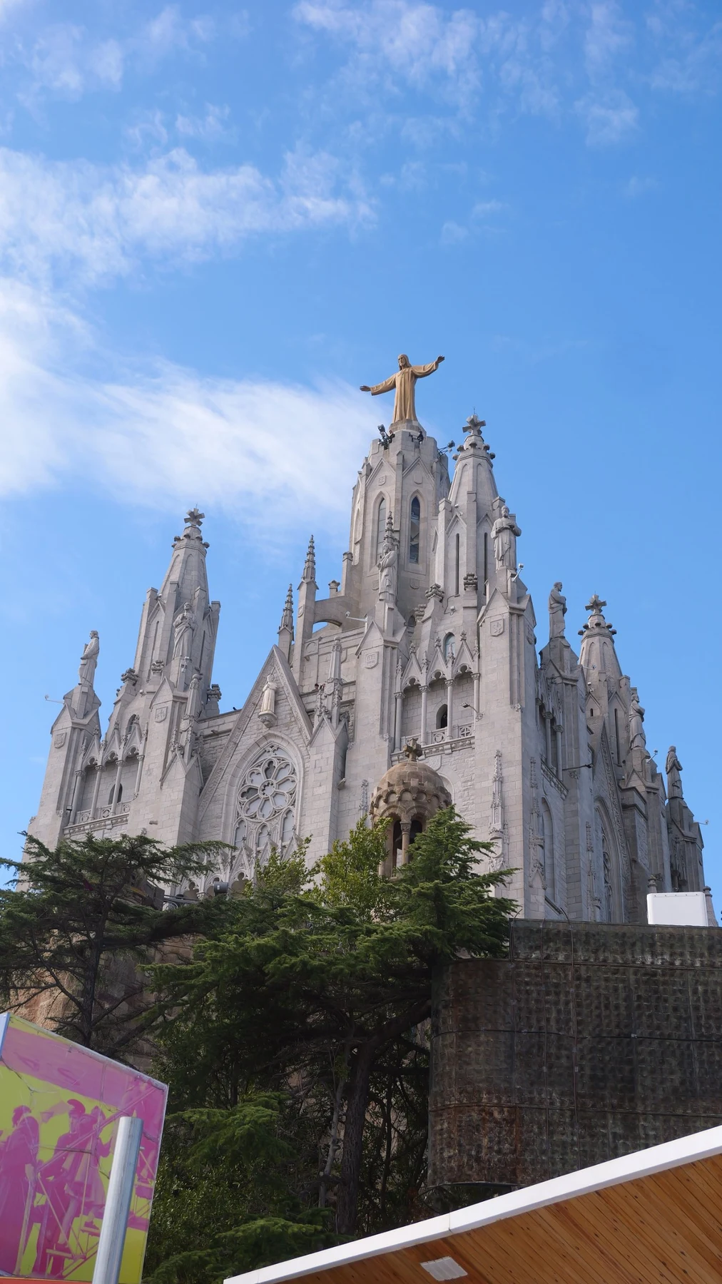 The Sagrat Cor church on Tibidabo in Barcelona, its spires topped with a golden statue against a blue sky